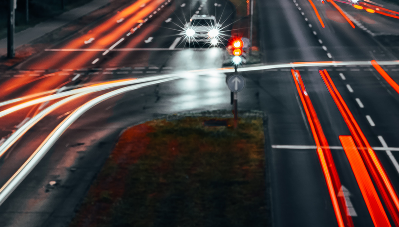 A car in the middle of the road with blurry traffic surrounding it. Photo: Florian Schwert on Pexels.